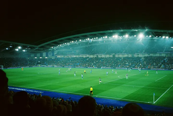 A soccer match in a stadium at night
