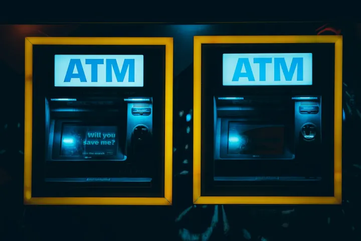 A couple of atm machines sitting next to each other