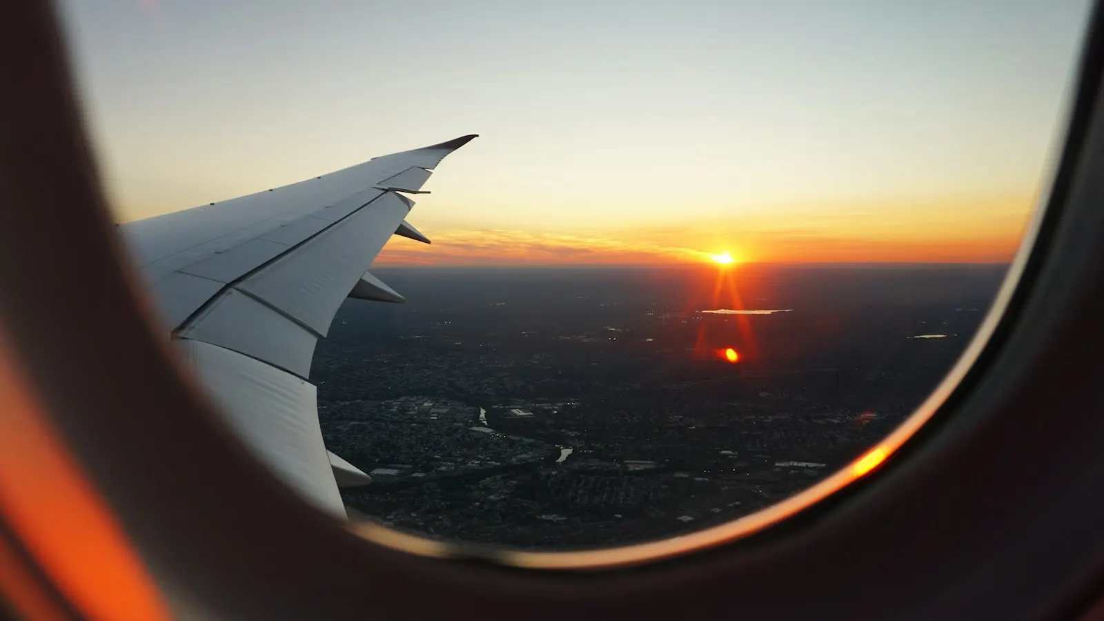 Airplanes window view of sky during golden hour