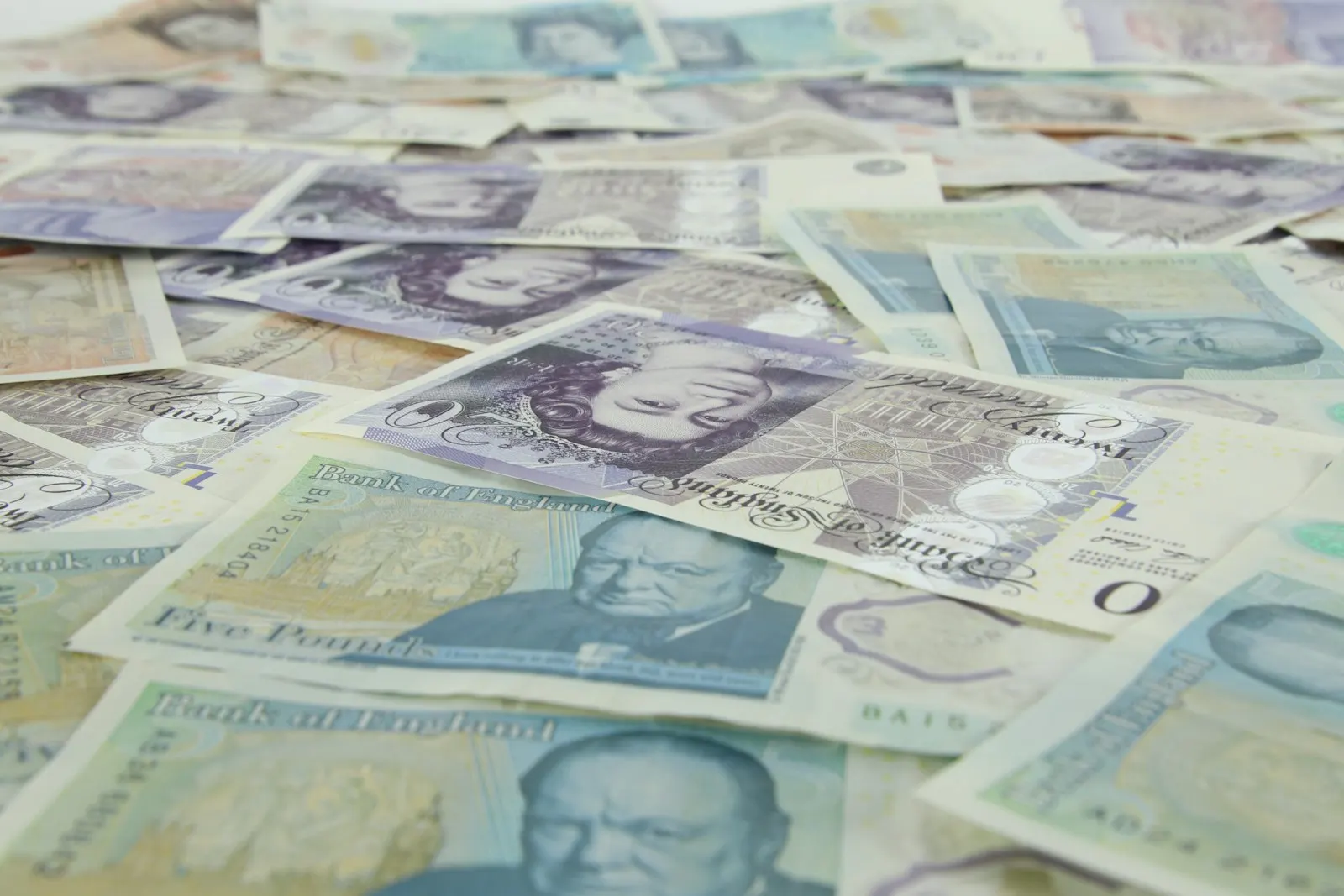 A scattered collection of british twenty and five pound banknotes