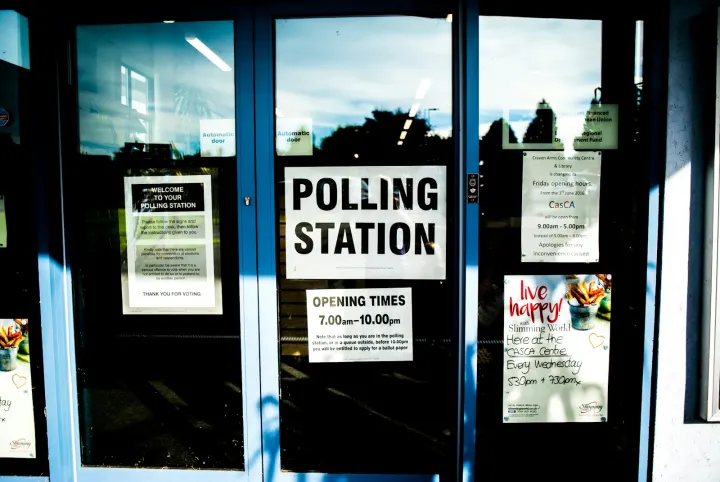 Polling station poster on clear glass door